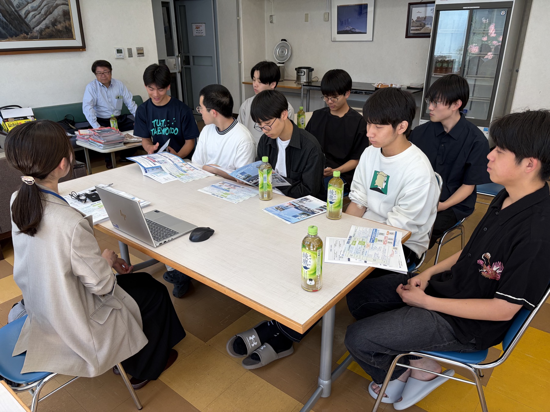 北陸電力の担当者が寮生に資料を示しながら説明する様子
